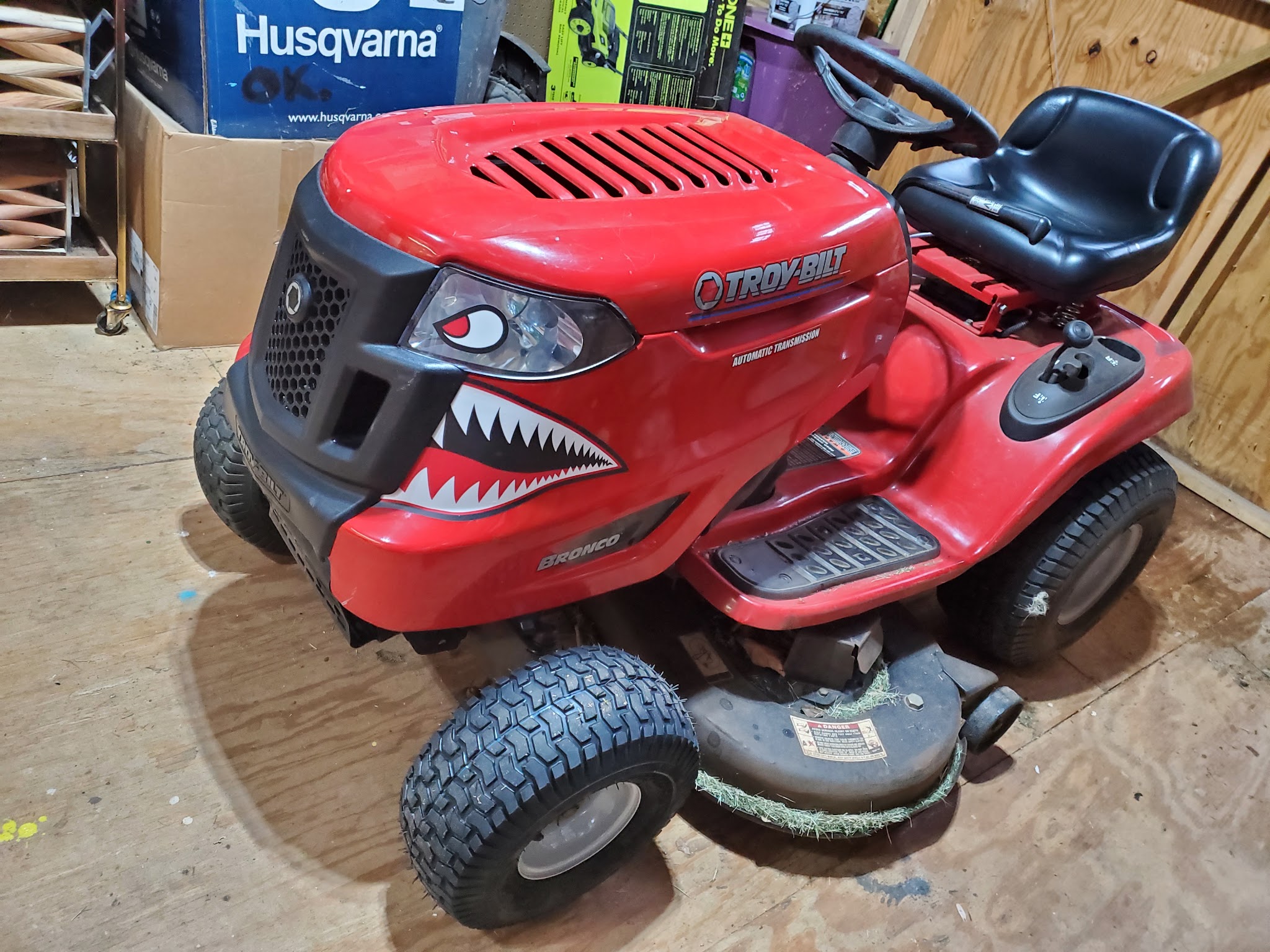 Red Troy-Bilt riding mower with a shark face on the hood