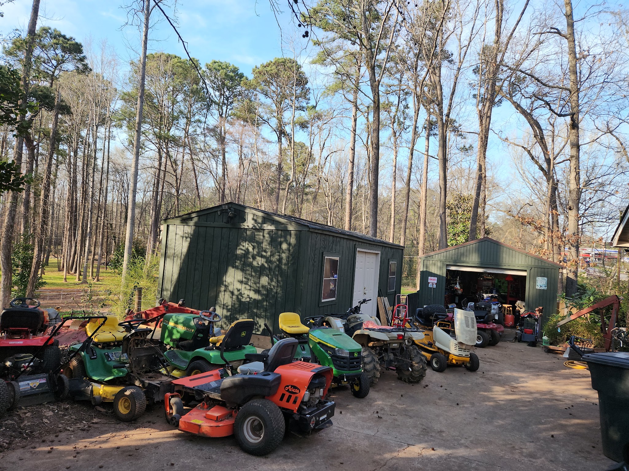 Yard full of riding mowers waiting for repair