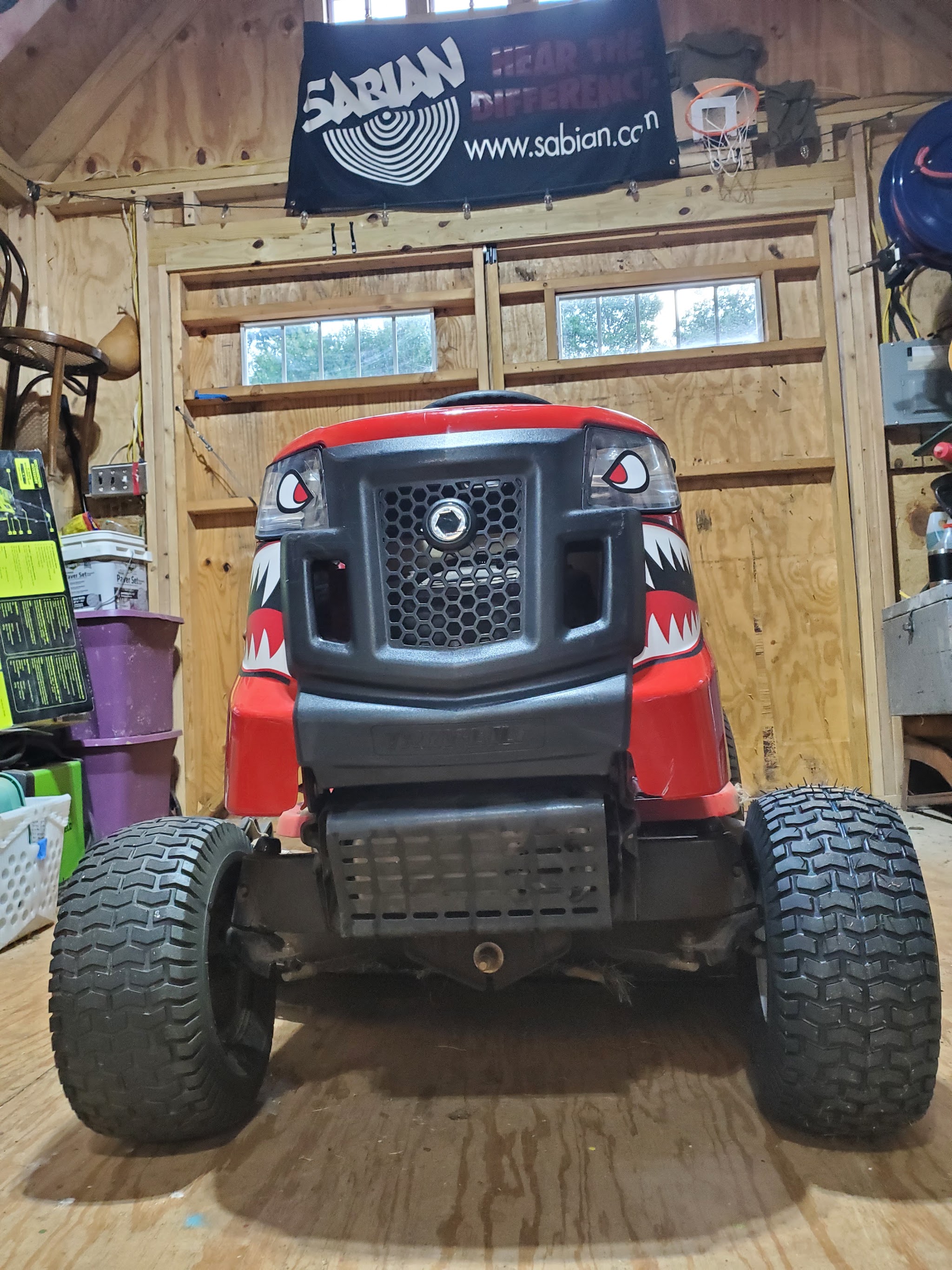 Front view of a riding mower with a shark face grille